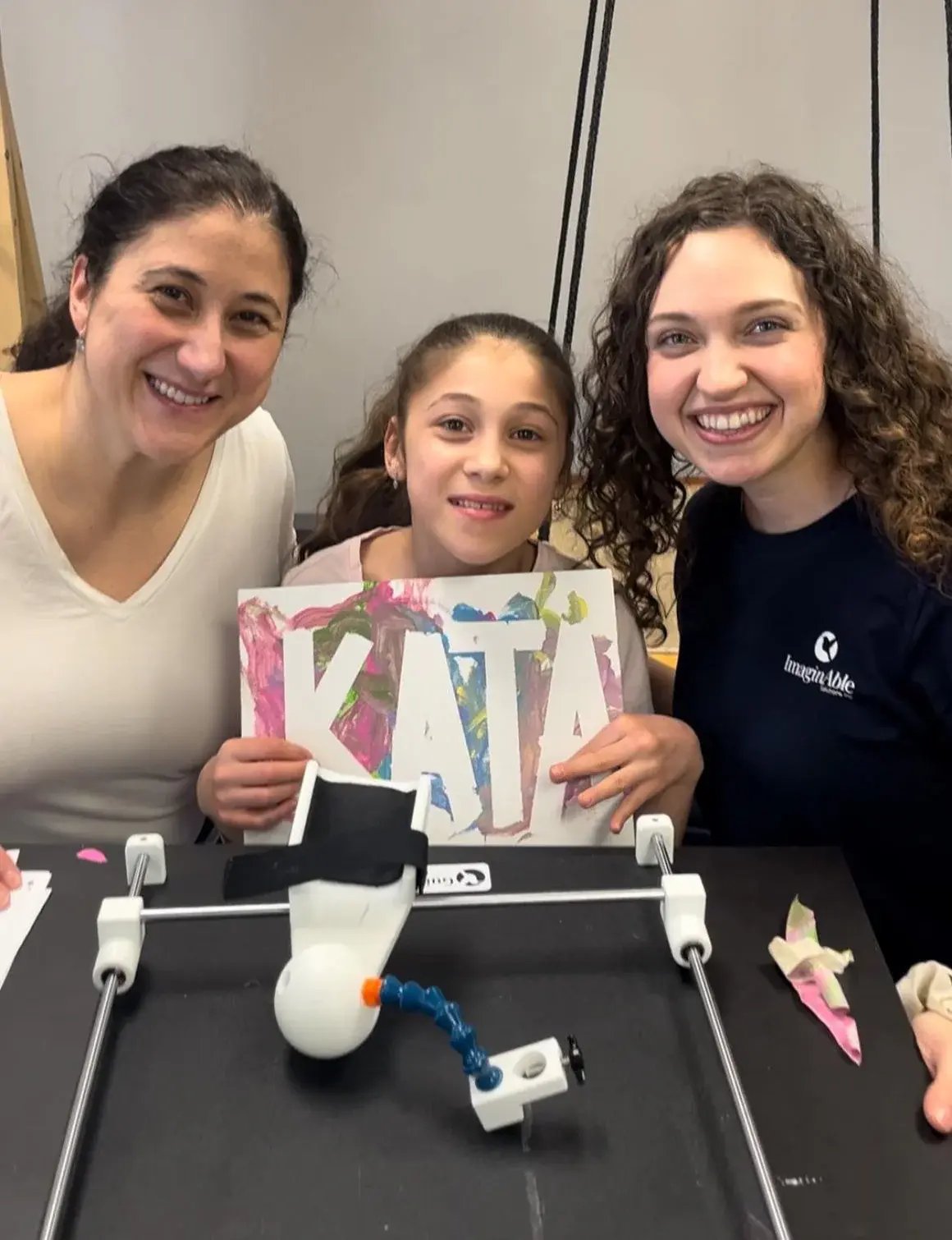 Girl showing painting she created with Guided Hands.
