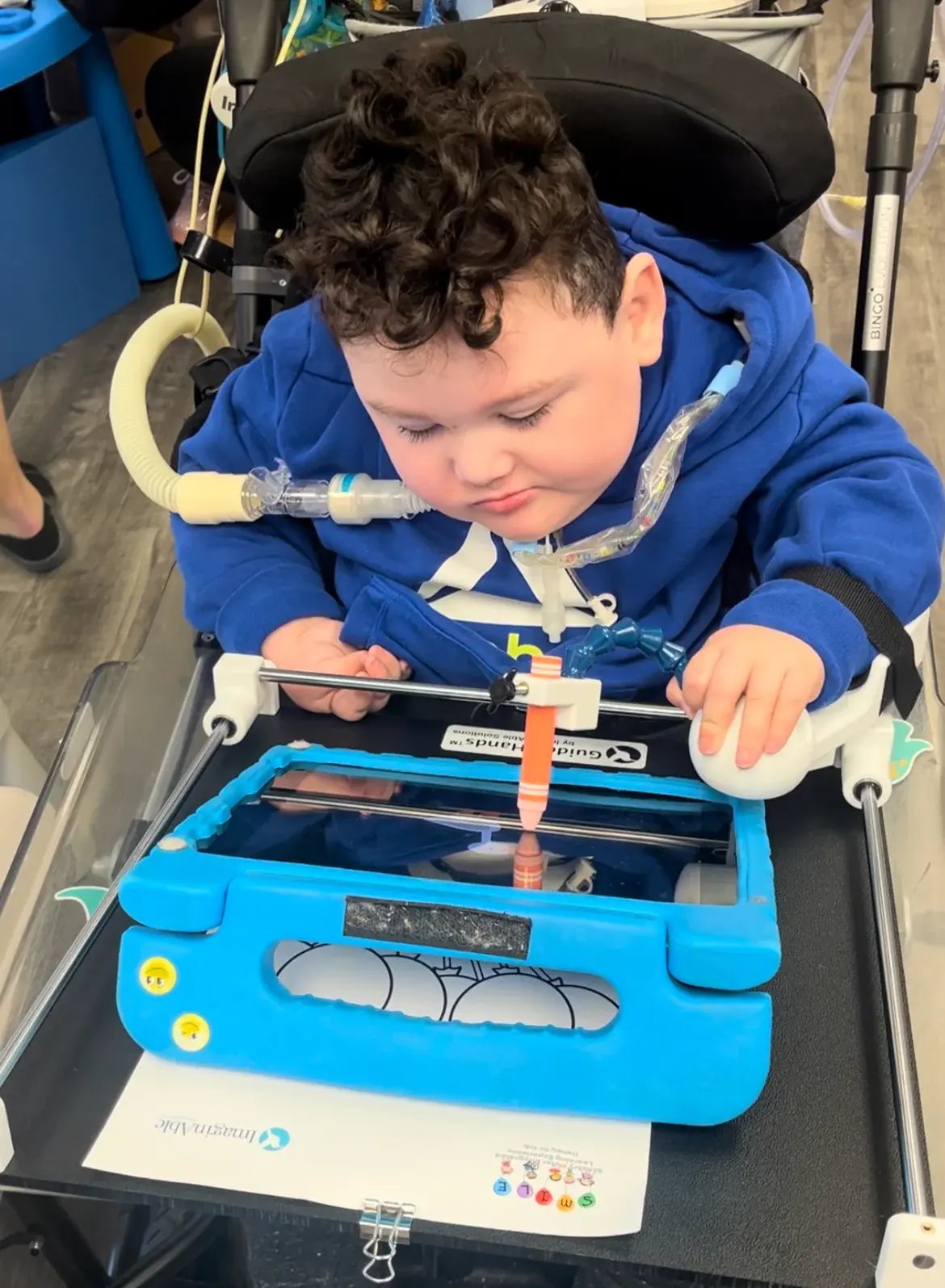 Child using Guided Hands with touchscreen device iPad Tablet